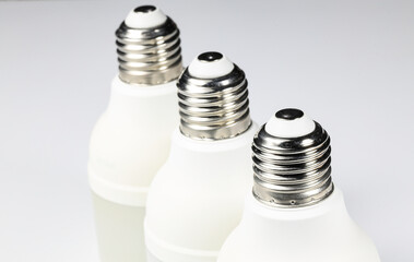 White LED bulb or light bulb with connector type e27 for energy saving with shallow focus isolated on white background.