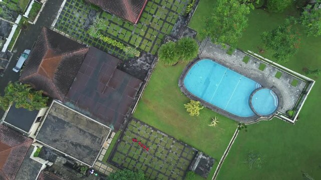 Aerial View of a Villa with a swimming pool on a Plateau Surrounded by trees