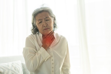 Sick senior woman touching neck unwell coughing with sore throat pain,lung...