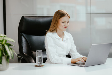 Young Professional Woman Working at Laptop