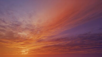 Fototapeta premium Stunning sunset over rolling hills, showcasing vibrant orange and purple hues in the sky, perfect for nature and landscape themes