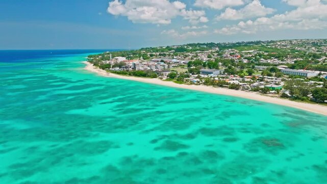 The west coast of barbados with turquoise waters and a stretch of sandy beach, aerial view