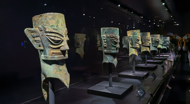 Chengdu, China - October 26, 2024: Masks and sculptures in the mysterious Sanxingdui culture. People are visiting. An archaeological site known for the discovery of aliens and an important Bronze Age 
