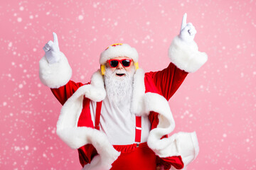 Photo of crazy funky santa claus enjoy listen x-mas christmas fairy jolly radio headphones raise fingers wear headwear sunglass suspenders isolated over pastel color background