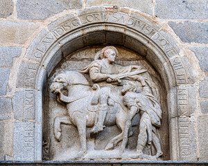 Stone relief sculpture of San Martin on the facade of the building, Avila, Spain