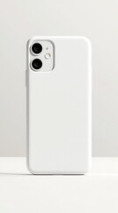 A plain white phone case displayed against a neutral background, showcasing its minimalistic design and dual-camera openings.