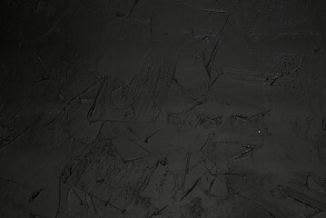 A black matte background with a delicate texture that creates a slight effect of depth. The surface...