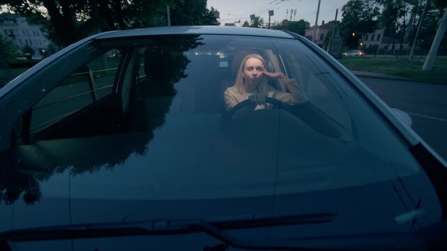 Bored exhausted Caucasian business woman female girl businesswoman car automobile driver holding head boredom asleep fatigue sleeping inside vehicle auto driving city street road at late evening night