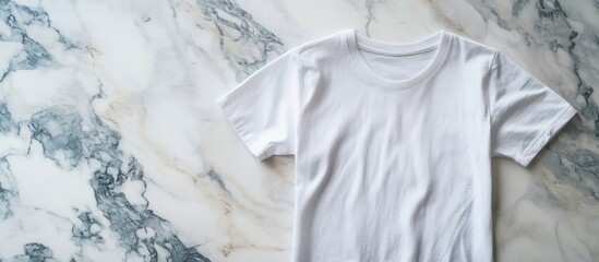 Blank white t-shirt mock-up on marble background.