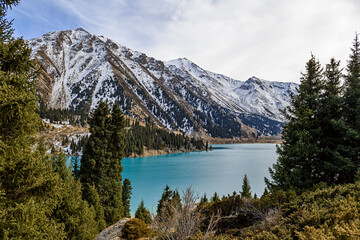 Beautiful mountain lake with ice and snow. Big Almaty lake in winter time. Kazakhstan.