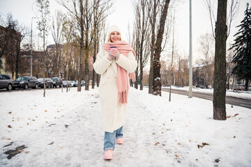 Photo of positive girl buy hot eggnog cacao walk rest relax on cold frosty december day outside