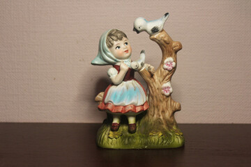 figurine of a girl and a bird