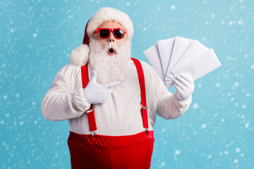 Portrait of his he nice attractive amazed stunned thick white-haired Santa holding in hand...