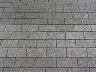 Obraz premium Gray square paving tile. Brick pavement texture. Concrete pavers background.