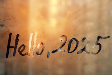 lettering Hello and numbers 2025 is twenty twenty-five of new year paint with finger on splashed by...