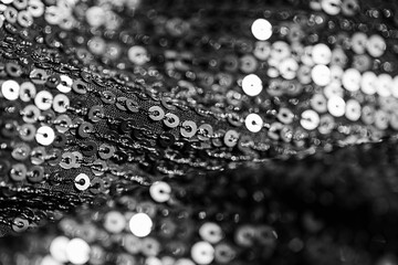 Abstract composition of fabric with shiny sequins. Holiday and party concept. Selective focus