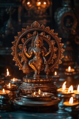 Fototapeta premium An elegant brass sculpture of the Hindu deity Laxmi in the Nataraja form, with lit candles creating soft lighting around it on an old wooden table. The background is dark and black to highlight 