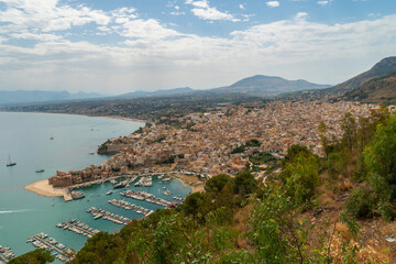 Obraz premium Aerial morning cityscape of Castellammare del Golfo town, .view of medieval fortress in Cala Marina, harbor, Mediterranean sea. Sicily, Trapani Province, Europe. Traveling concept background.