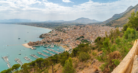Fototapeta premium Aerial morning cityscape of Castellammare del Golfo town, .view of medieval fortress in Cala Marina, harbor, Mediterranean sea. Sicily, Trapani Province, Europe. Traveling concept background.