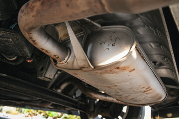 exhaust system close-up of car seen from below background