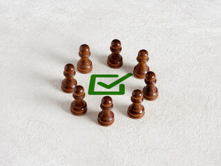 A group of people gathered around the checkmark.