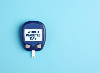 Health care and diabetes concept. Glucometer with world diabetes day written on its screen.