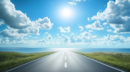 Fototapeta premium Scenic road leading to ocean under bright blue sky with clouds