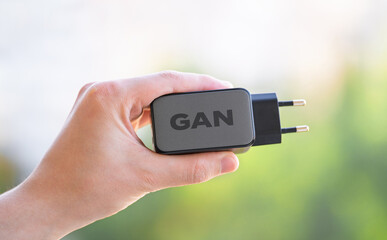 Black phone AC charger and USB cable on white background. Gan