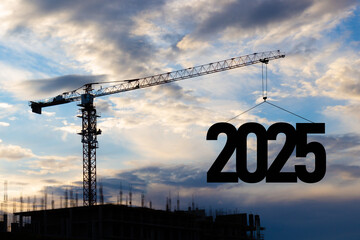 2025 New Year for planning and strategies concept. Silhouette of a construction crane against blue...