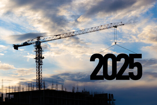 2025 New Year for planning and strategies concept. Silhouette of a construction crane against blue cloudy sky at a construction site raising the number 2025 year. Ideas of development and investment