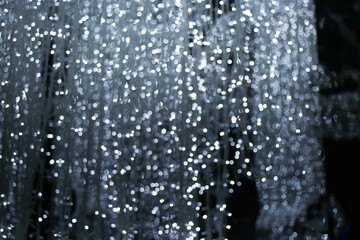 field of blur bokeh glowing white snow light dots dust bulb with dark black background 