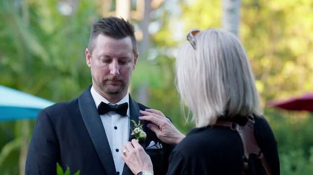 Nervous Groom Having Buttonhole Boutonniere Arranged By Mother On Wedding Day, 4K Resolution Slow Motion