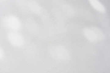 close up on white plain wall background texture with shadow of window from sunlight for ads and...