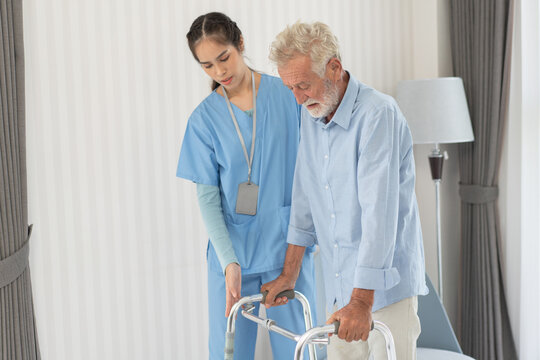 Nurse caregiver support helping senior man walking with walker. Exercise for physical therapy after sickness. Therapist take care of grandfather in nursing home. healthcare and medical insurance