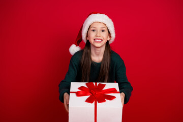 Photo portrait of charming little girl amazed hold present dressed green christmas garment celebrate winter holidays on red background