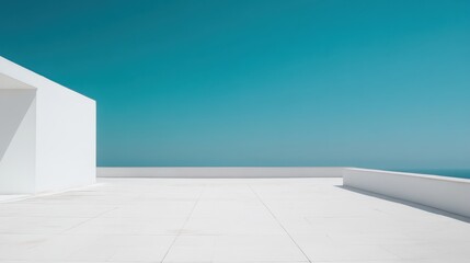 A serene, minimalist terrace with a white architectural structure overlooks a tranquil sea under a clear blue sky.