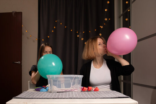 Women Blowing Up Balloons for Party Decoration, planning a birthday celebration with family, indoors decorating for a traditional holiday