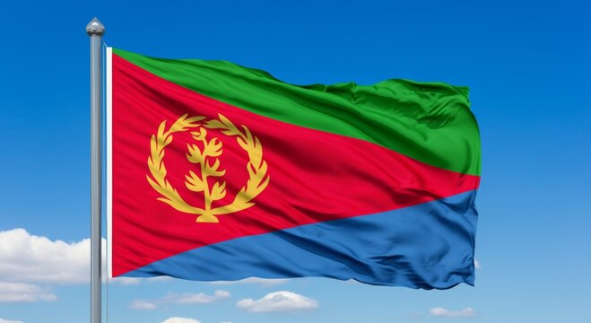 Eritrean national flag waving against blue sky.
