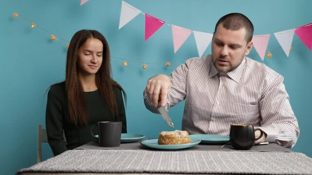 family celebration, father and daughter eating birthday cake, sweet cream dessert at table