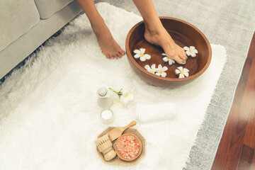 Panorama top view woman indulges in blissful foot massage at luxurious spa salon while masseur give...