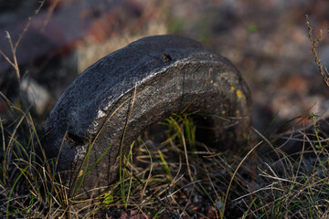 An old, thick, rusty hook sticks out of a brick fortress