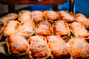 Mini lasagna servings arranged on a medium-sized tray