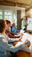 Project leader outlines strategic plan on whiteboard, with team members actively engaged in...
