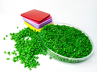 Green polymer masterbatch granules isolated on white background for plastic product profile catalog...