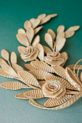 Decoration of straw on the green background. Branch with flowers. Top view. Straw weaving. Decor