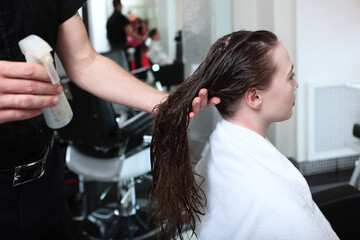Hair care in beauty salon. Moisturizing and nourishing long hair. Concept of beauty.