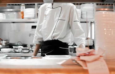Restaurant Busy Kitchen, Chefs and Cooks Working on their Dishes