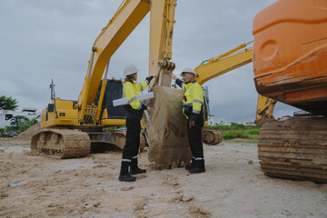 Construction engineers are discussing and using machinery and macros for large-scale construction...