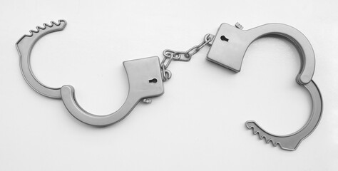 1 one alone Toy grey gray plastic handcuffs. Closed and open handcuffs isolated on white...