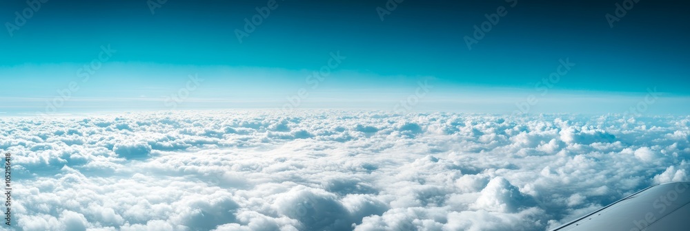 Poster the wing of an airplane is visible as it is flying above a beautiful cloudscape, creating a sense of